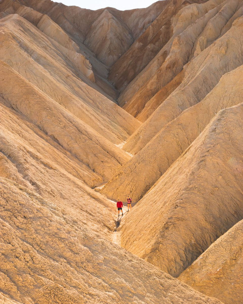 couple hiking through Golden Canyon in Death Valley National Park