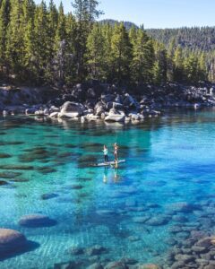 Couple paddle boarding on Lake Tahoe in the Summer