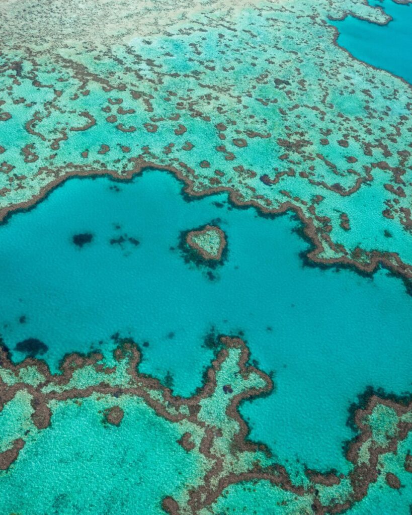 Flying Over Heart Reef with Hamilton Island Air. Copyright @ The Lovers Passport 2023.