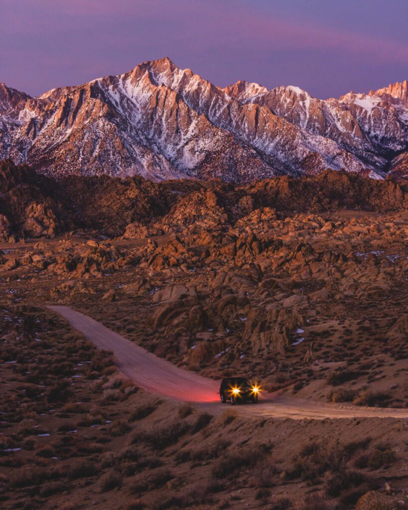 driving a car through Alabama Hills towards highway 395 