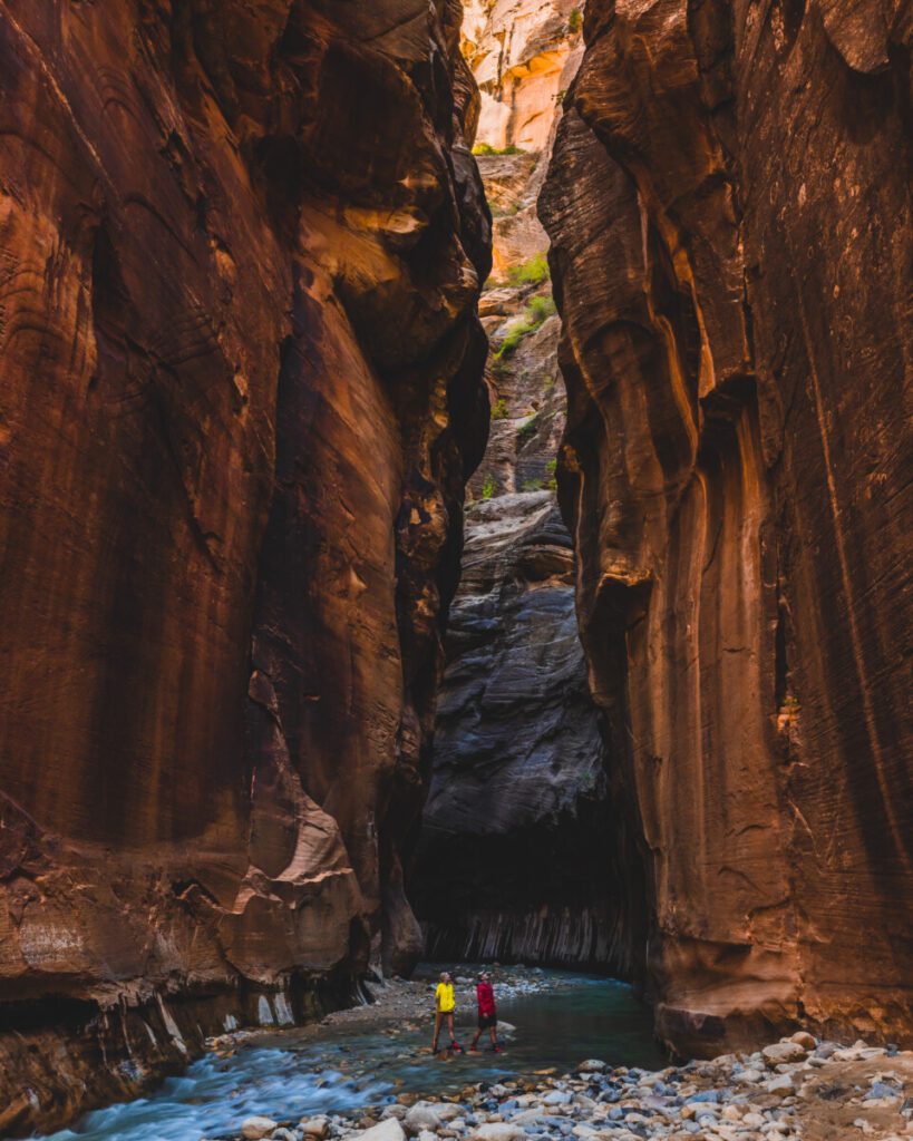 Adventure travel couple hiking the Narrows in Zion National Park