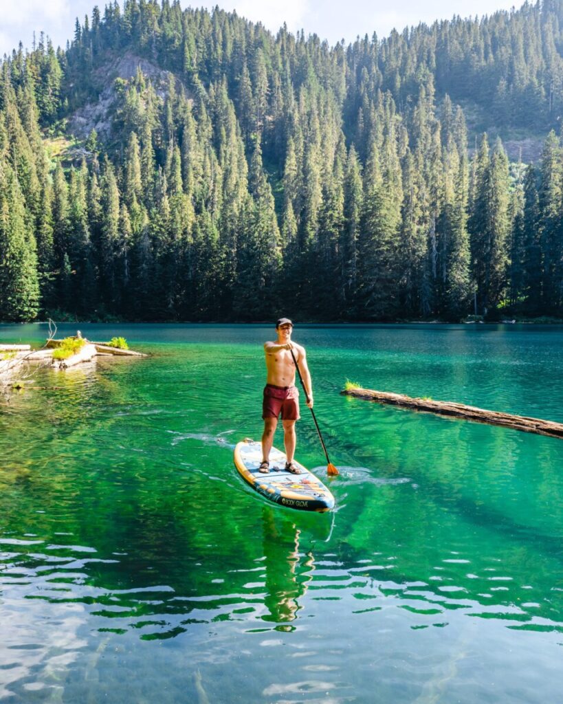 Man paddle boarding on Bertha May Lake in Washington state