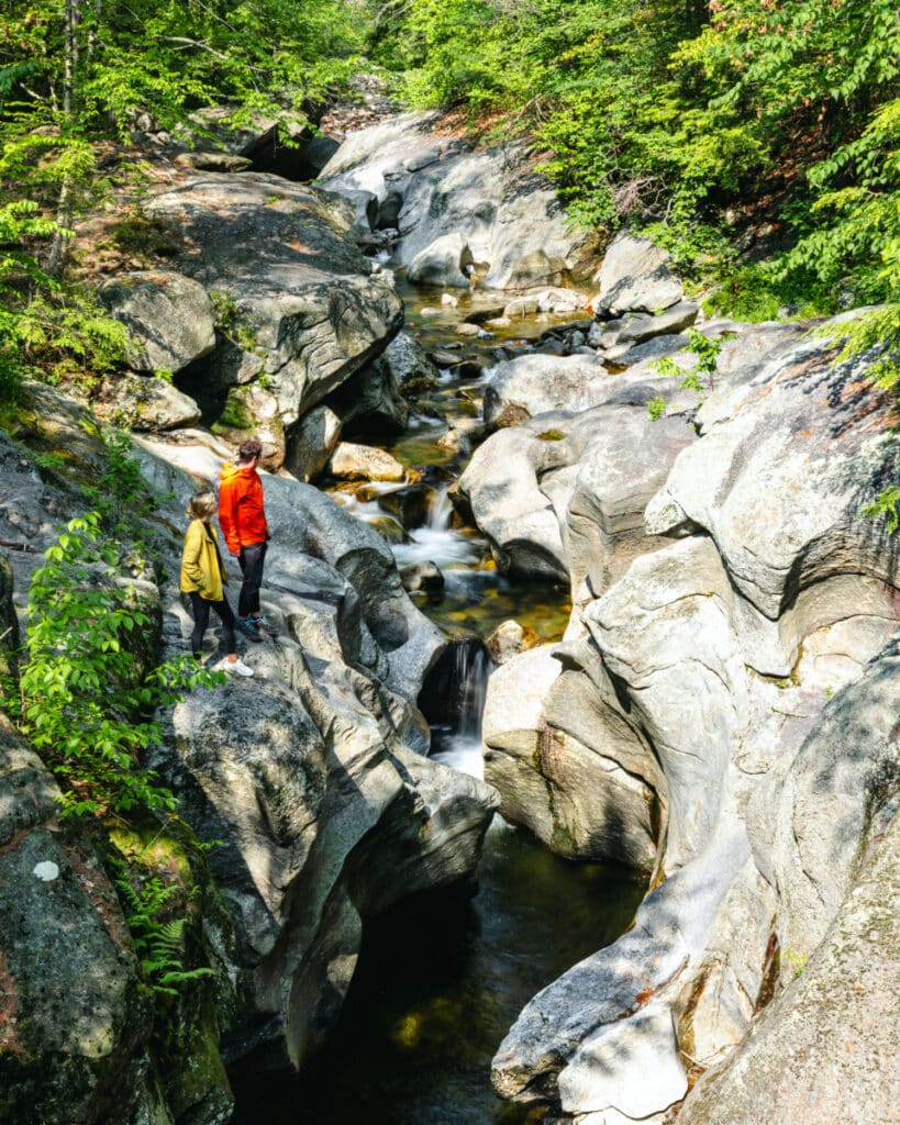 Couple stopping at Sculptured Rocks on a New Hampshire summer road trip