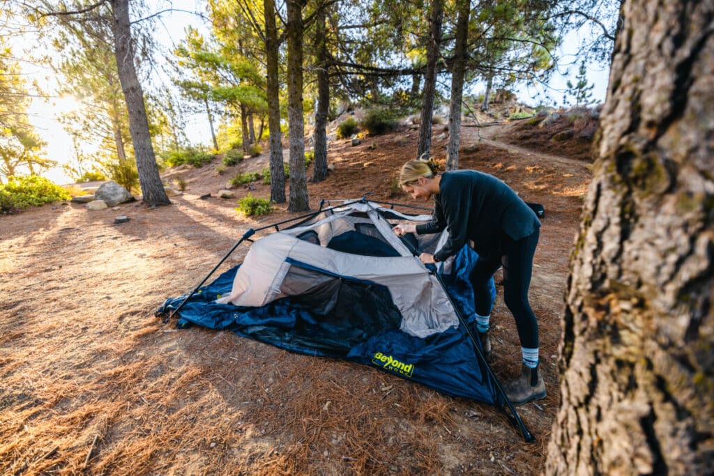 Woman setting up a tent