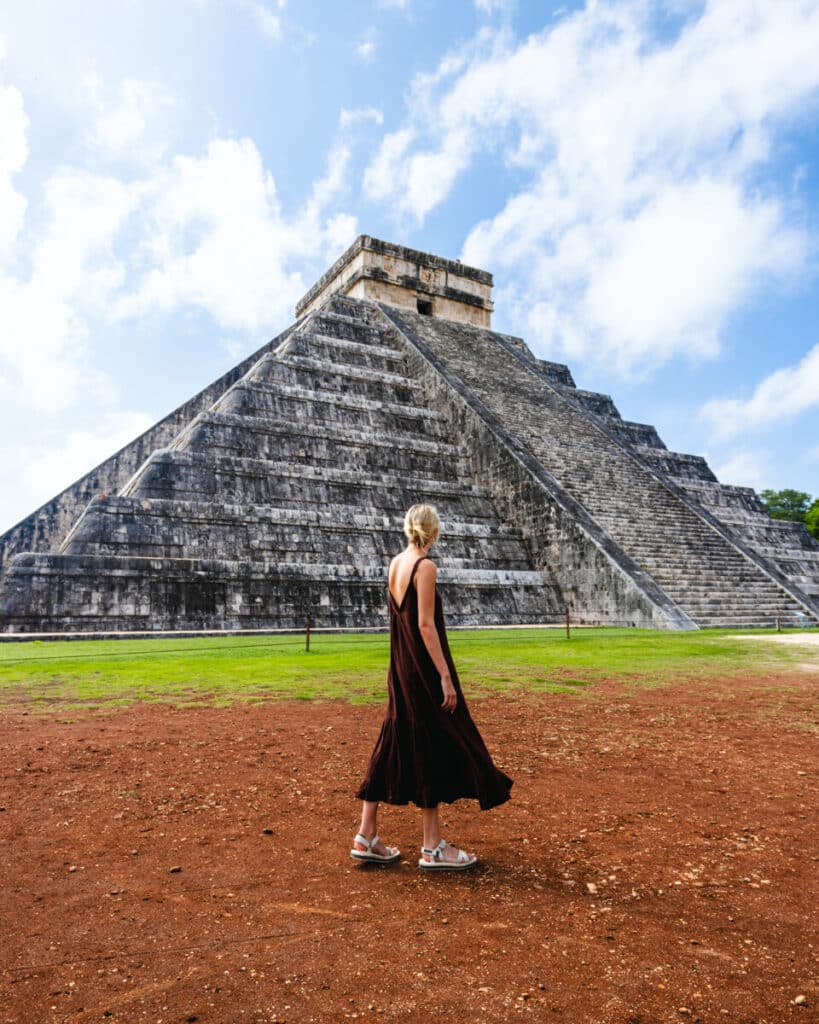 Standing in front of mayan temple at chichen itza