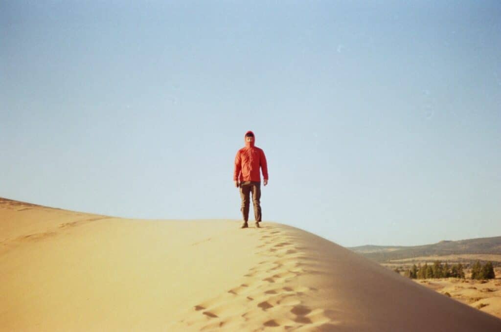 Man standing on Coral Pink Sand Dunes near Kanab