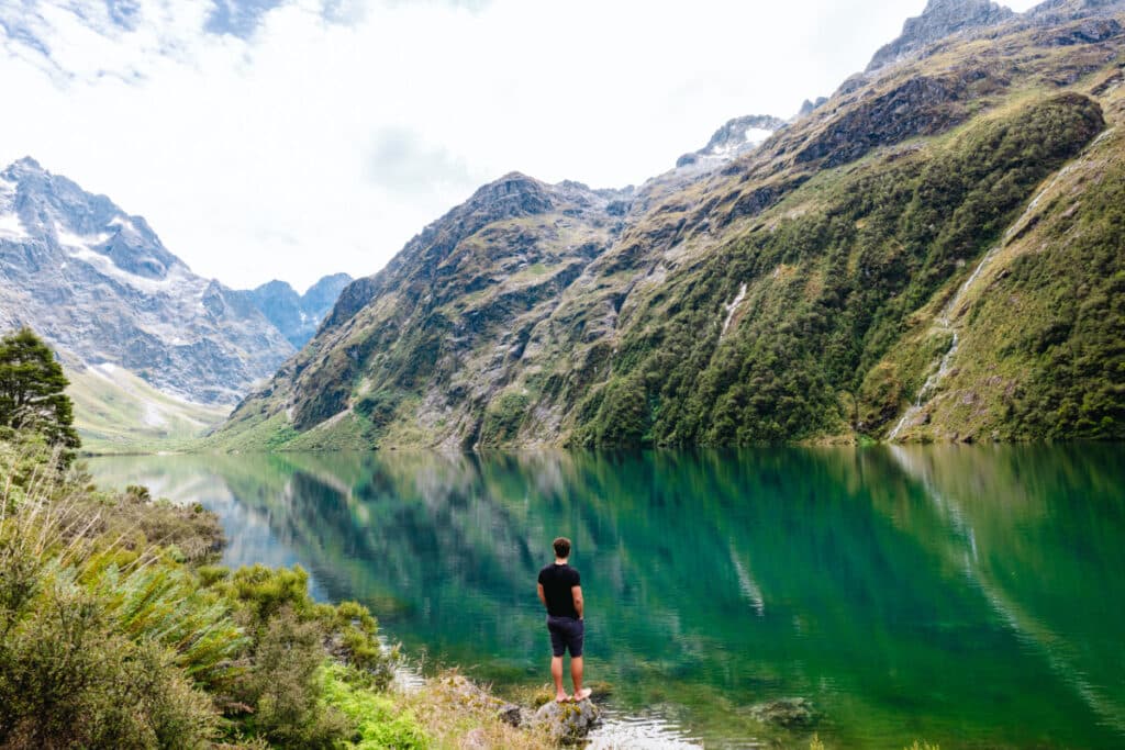 Man standing in Lake Marian in Fiordland National Park