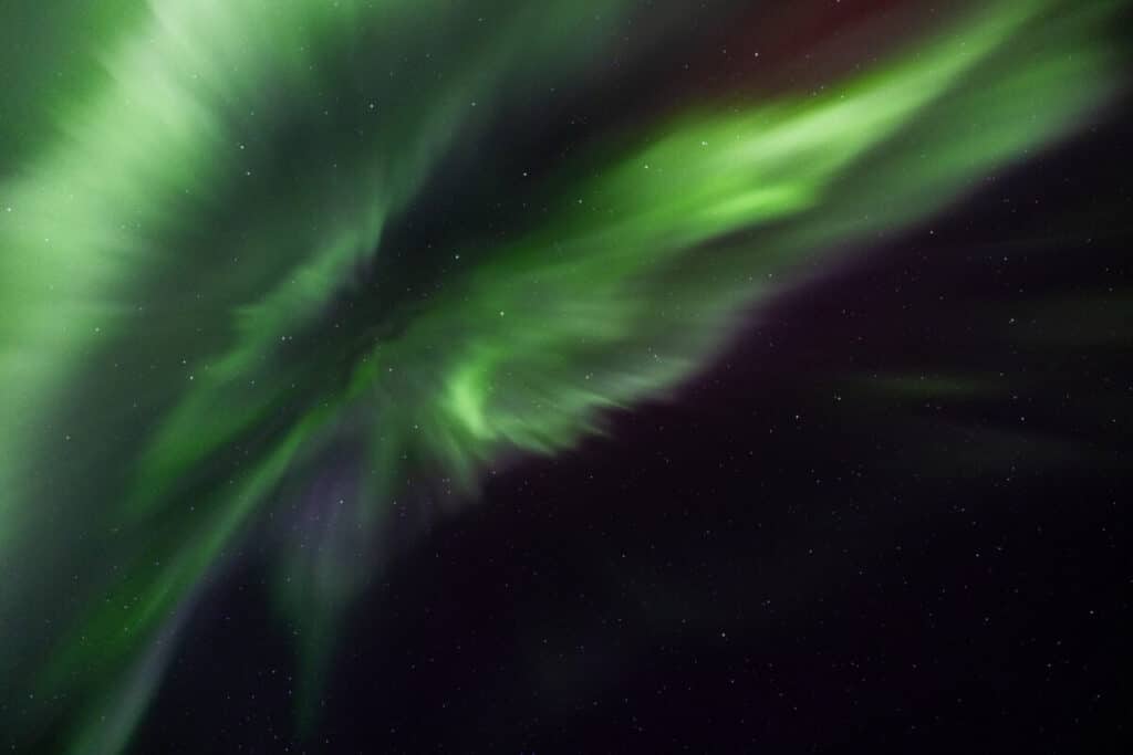 Aurora Borealis dancing overhead in the sky above Lofoten.