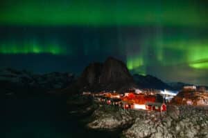 Northern Lights dancing above rorbus in Hamnoy, Lofoten Islands, Norway