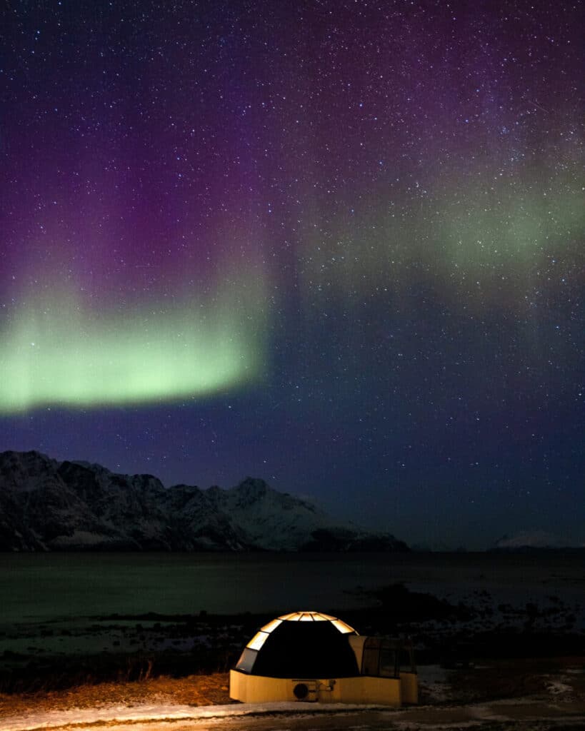 Northern Lights above an Aurora Glass Igloo Lyngen Alps, Norway