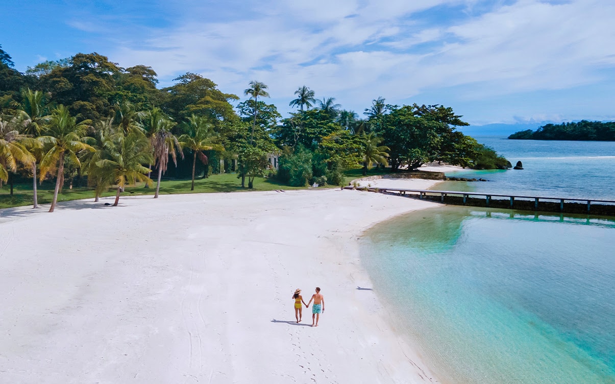 A Couple Walking on a Beach