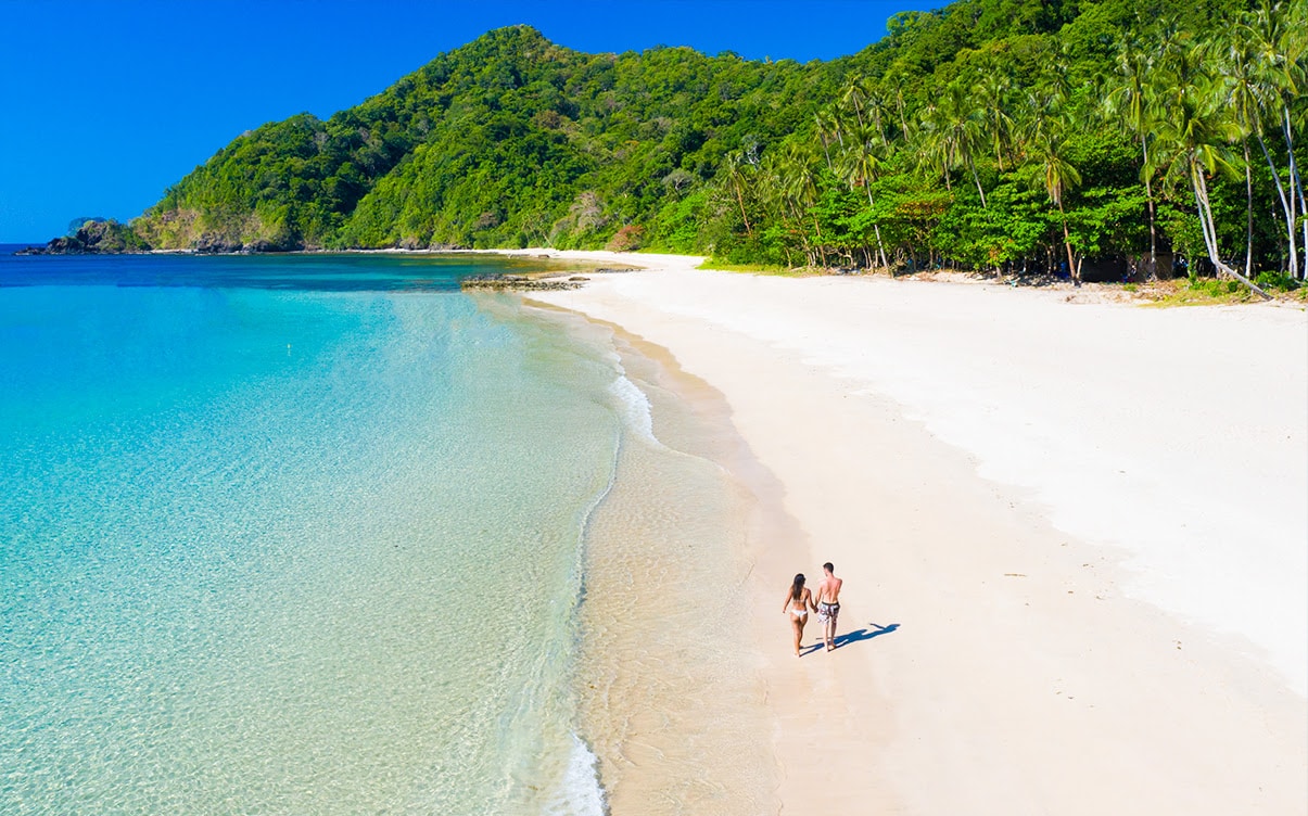 A Couple Walking on a Beach in El Nido Philippines