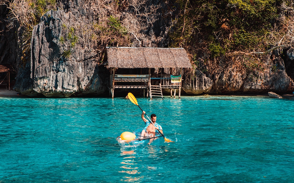 A Man Kayaking in Coron Philippines