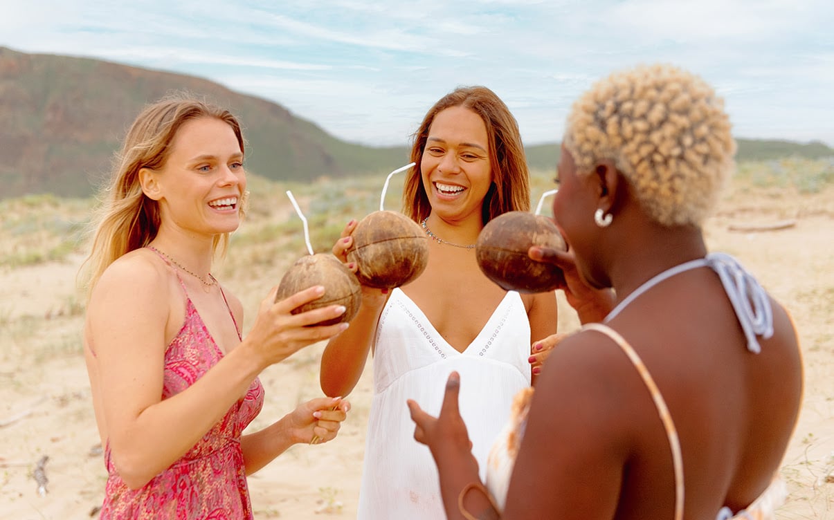 Women Drinking Tropical Coconut Beverages