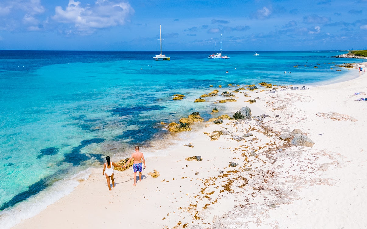 A Couple Walking on Eagle Beach in Aruba