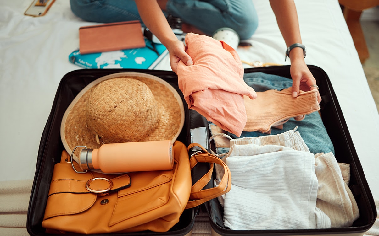 A Person Packing a Suitcase