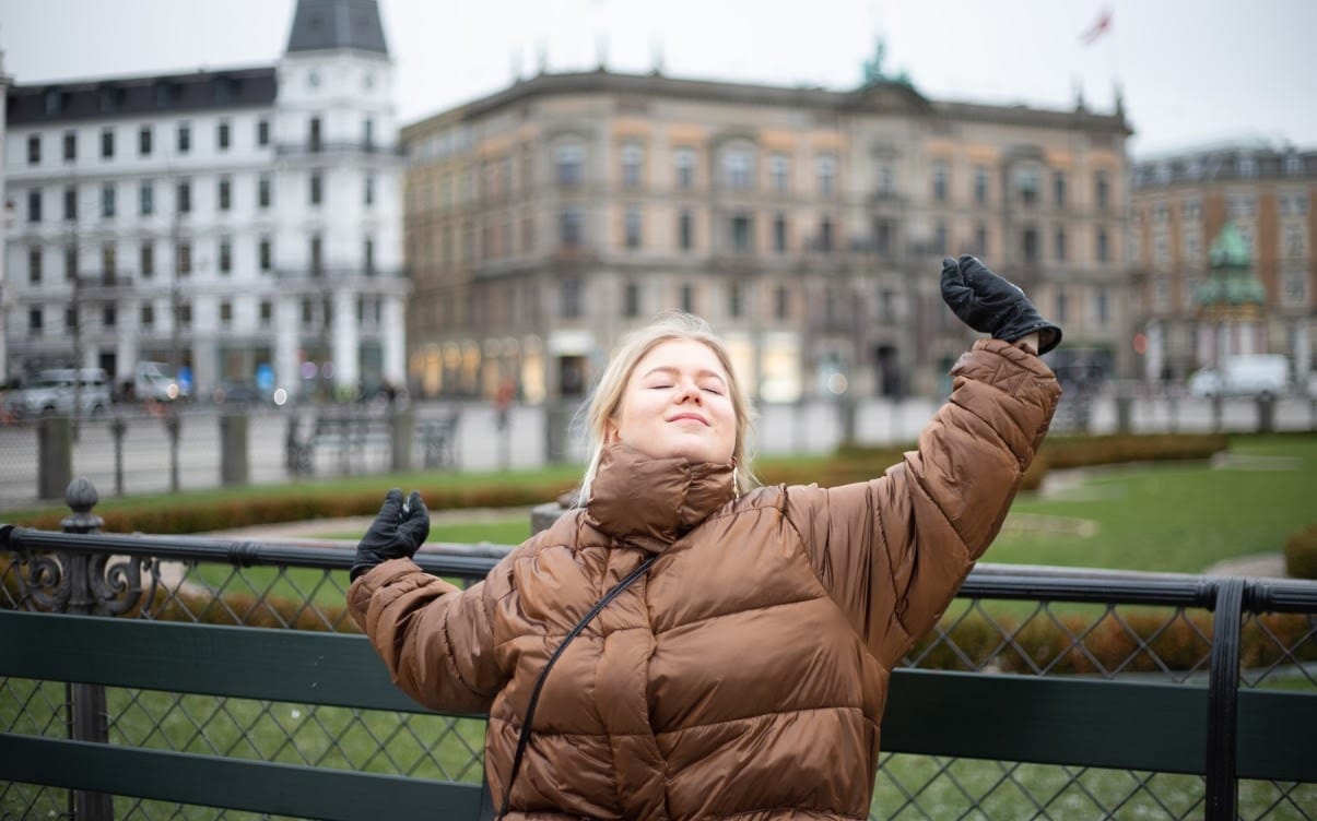 A Woman Wearing a Jacket in a City