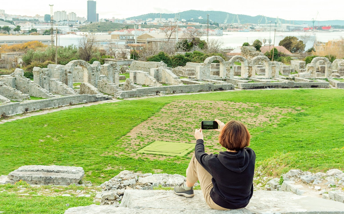 A Woman Taking Photos of the Ruins of Salona