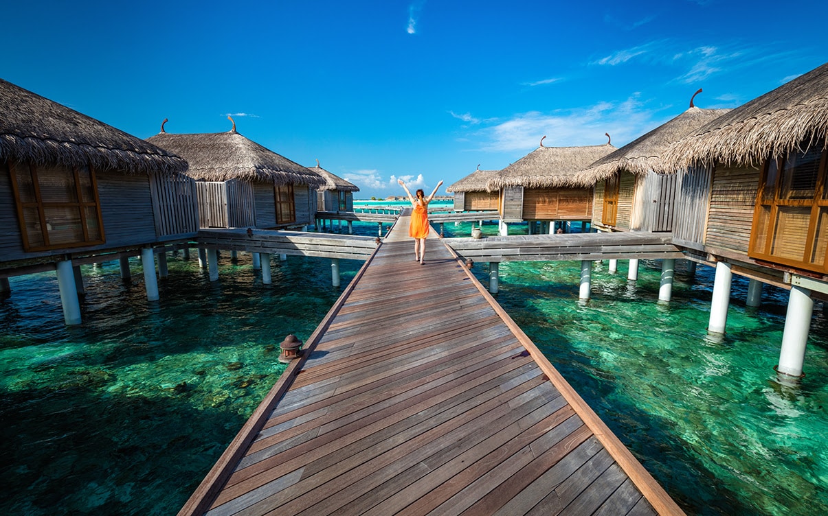 A Woman at an Overwater Bungalow Resort