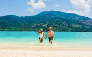 A Couple Walking on a Tropical Beach