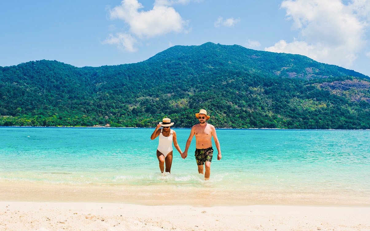 A Couple Walking on a Tropical Beach