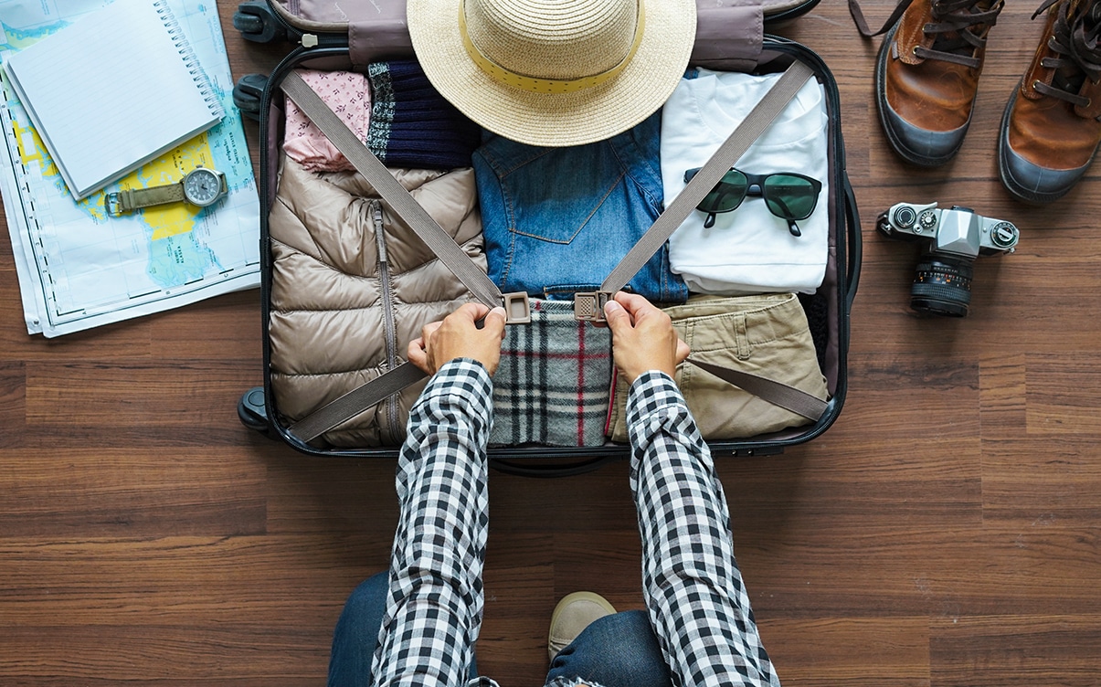 A Person Packing a Suitcase