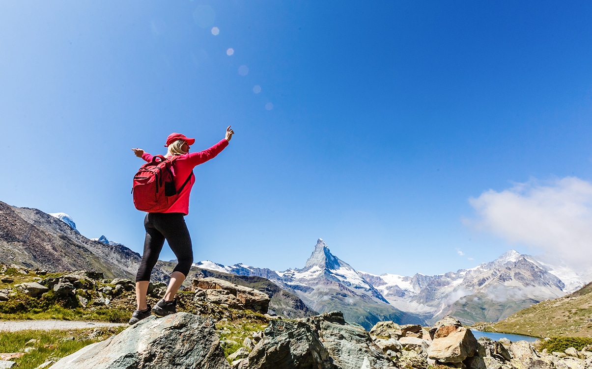A Woman Hiking in the Swiss Alps