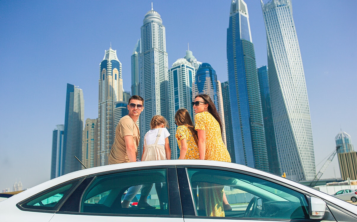 A Family Sitting on a Car in Dubai