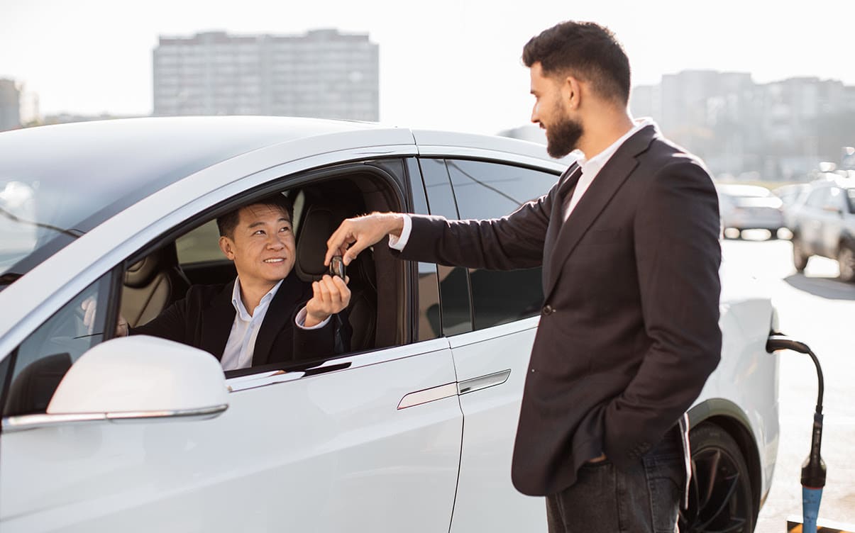 A Man Receiving Keys to a Rental Car