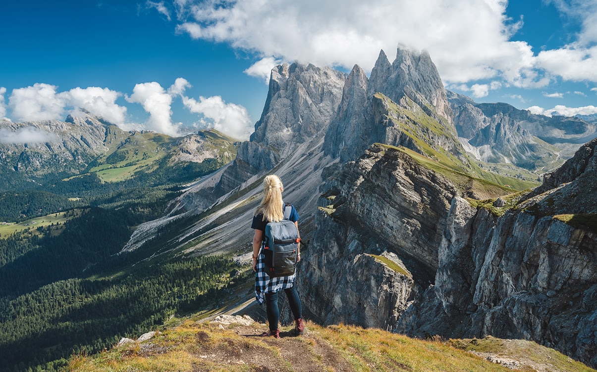 A Woman Standing at a Peak in the Dolomites