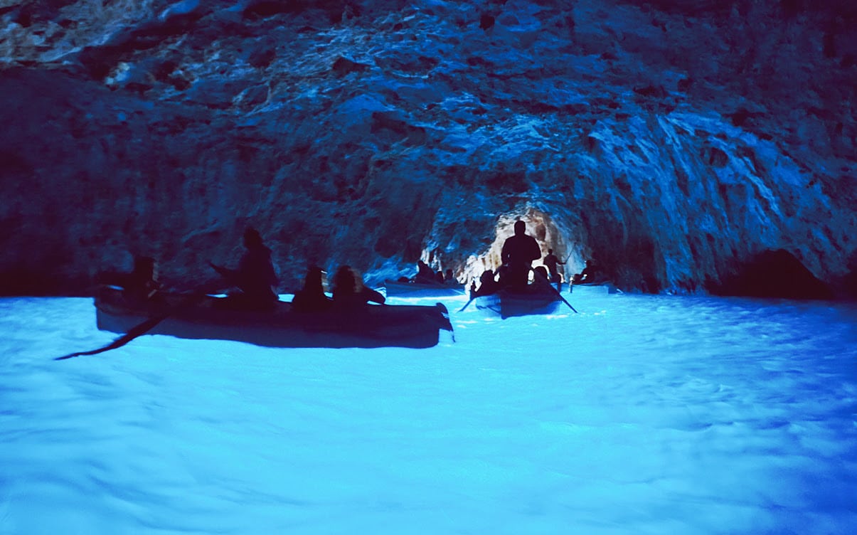 Boat Tour Groups Inside a Blue Cave