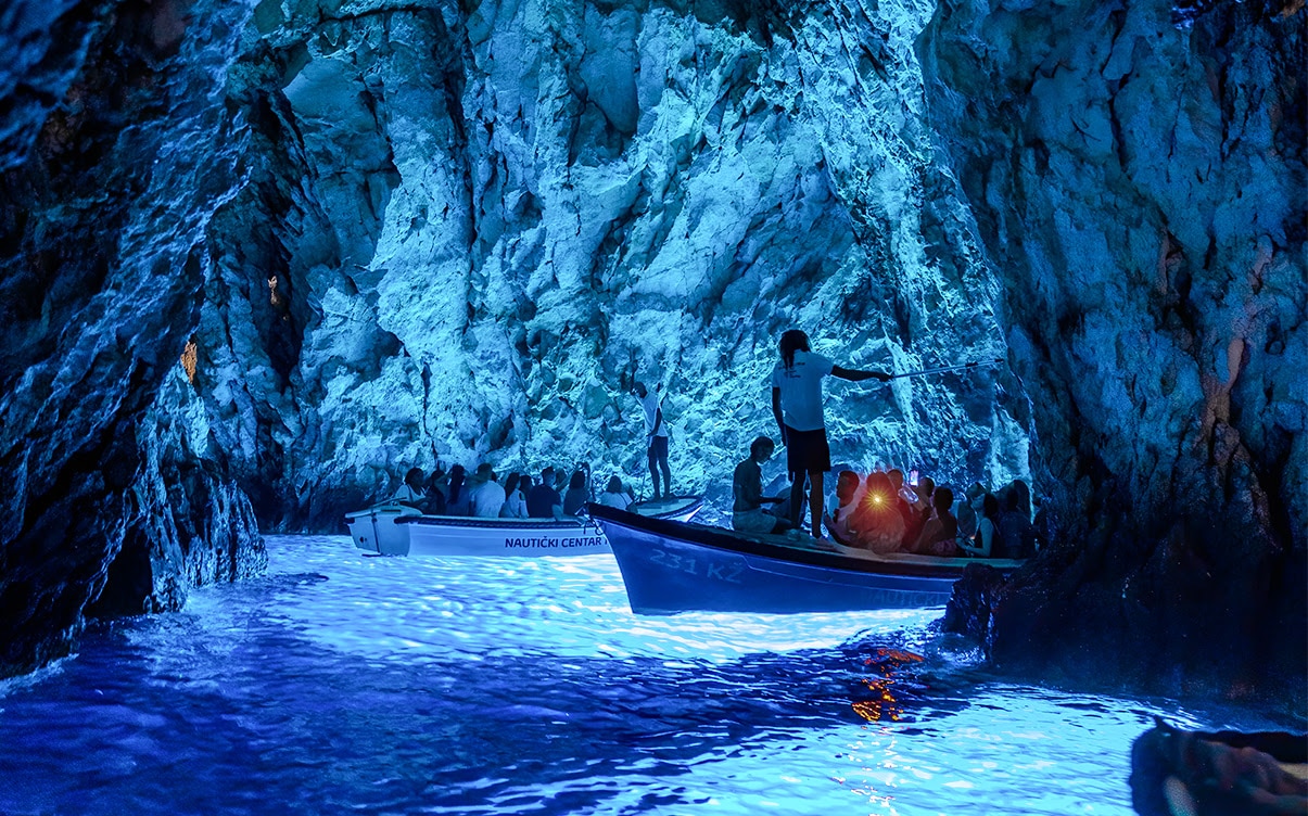 Boats in the Blue Cave in Croatia Boats in the Blue Cave in Croatia