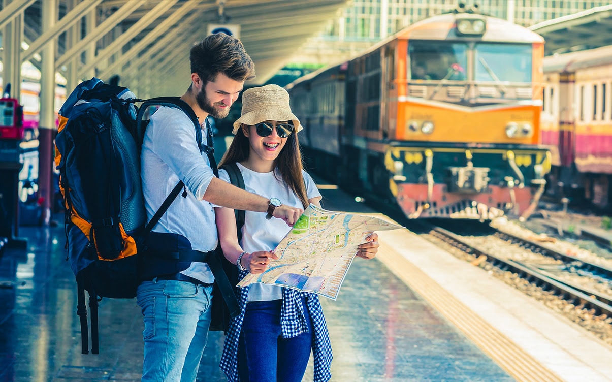 A Couple Looking at a Map at a Train Station