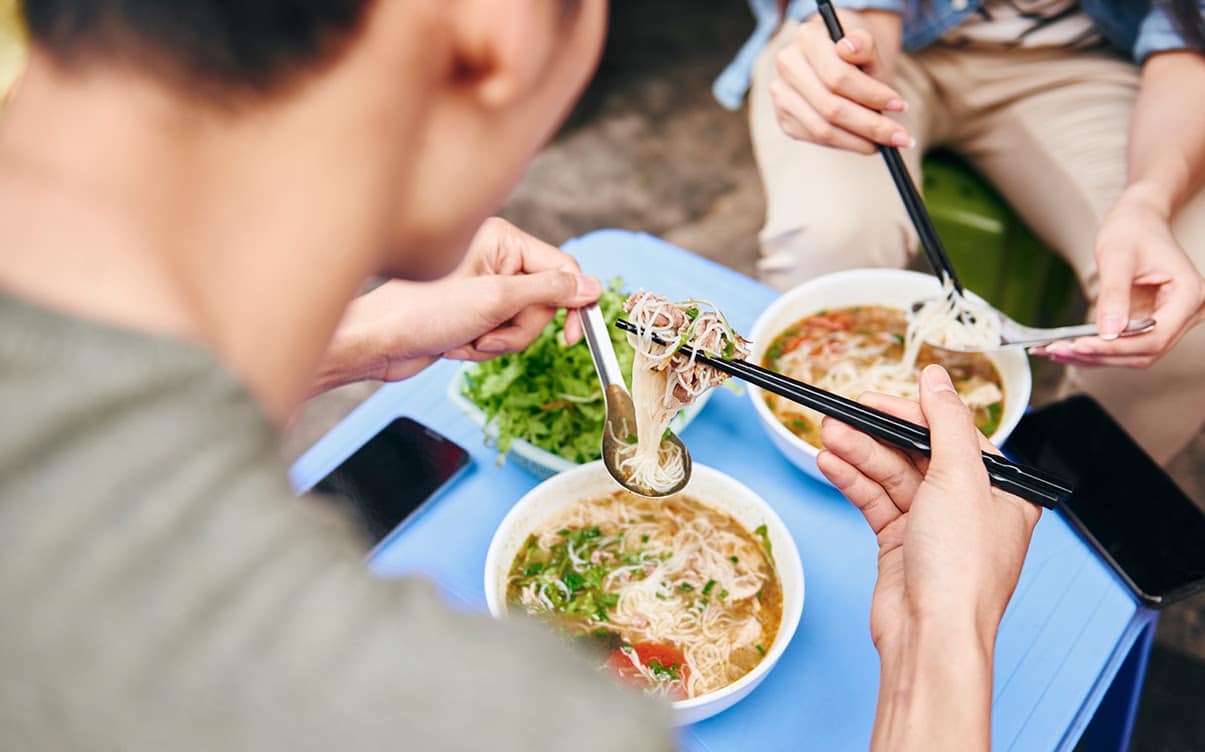 People Eating Vietnamese Street Food