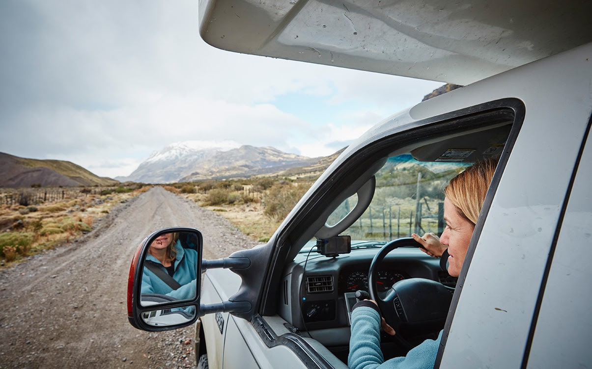 A Woman Driving on a Dirt Road