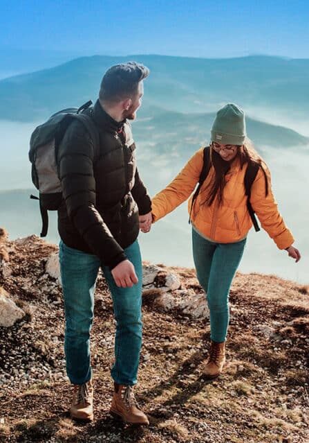 A Couple Hiking Up a Mountain