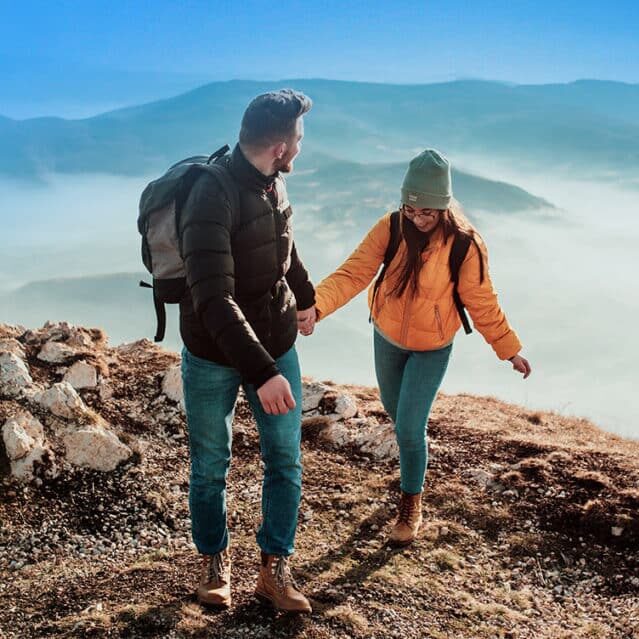 A Couple Hiking Up a Mountain