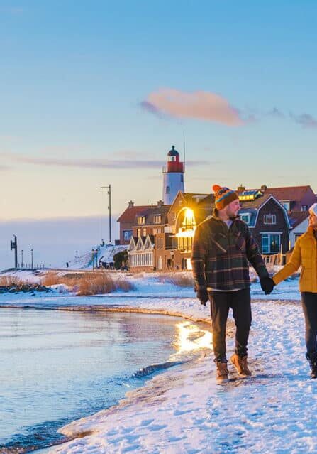 A Couple Walking on a Beach in Winter