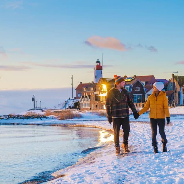 A Couple Walking on a Beach in Winter