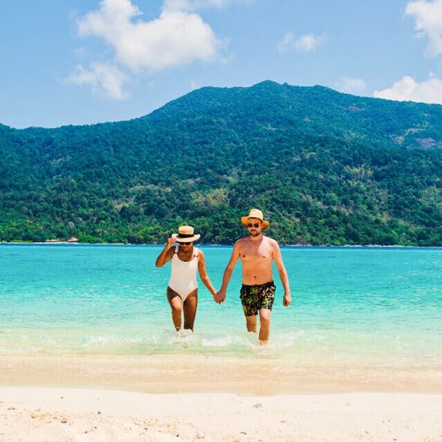 A Couple Walking on a Tropical Beach