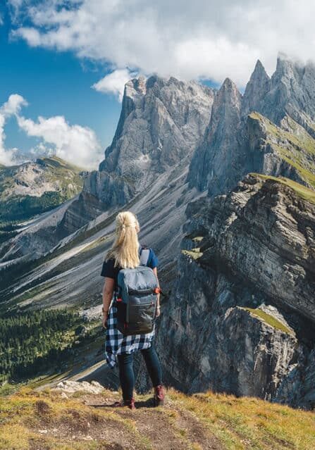 A Woman Standing at a Peak in the Dolomites
