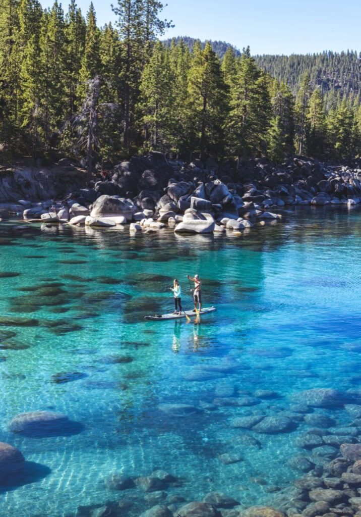 Couple paddle boarding on Lake Tahoe in the Summer